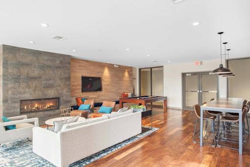 A modern living room with a fireplace and a dining area.