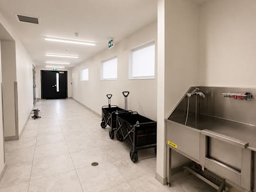 A clean, empty hallway with a stainless steel oven on the right.