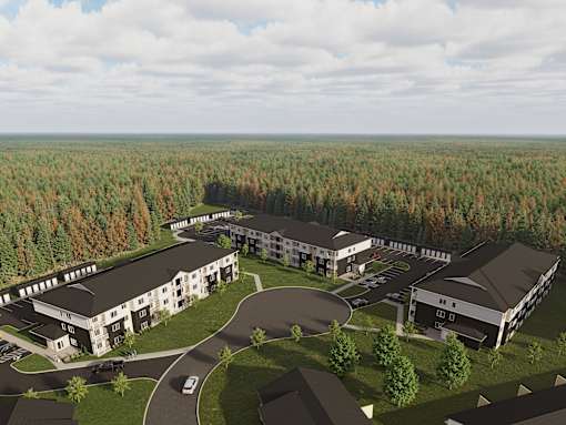 A large building complex surrounded by trees.
