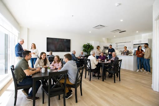 A group of people are gathered in a modern room.