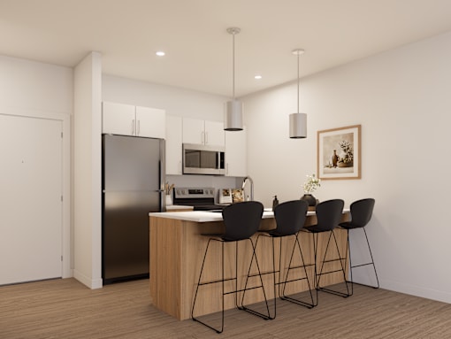 A modern kitchen with a refrigerator, sink, and bar stools.