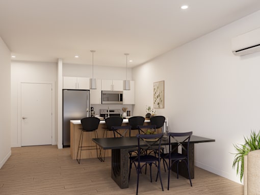 A modern kitchen with a dining table and chairs.