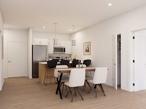 A modern kitchen with a dining table set for four.