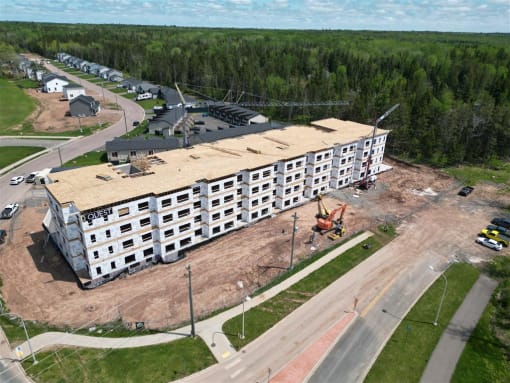 an aerial view of a building being constructed next to a road
