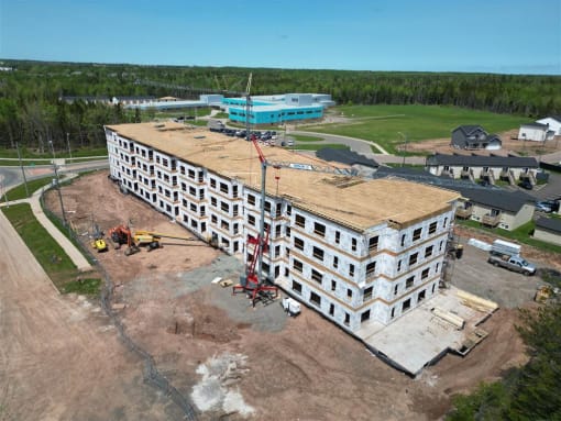 an aerial view of a large building under construction with a crane