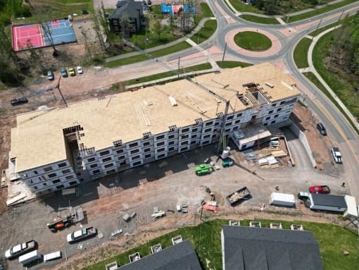 an aerial view of a building being constructed next to a road