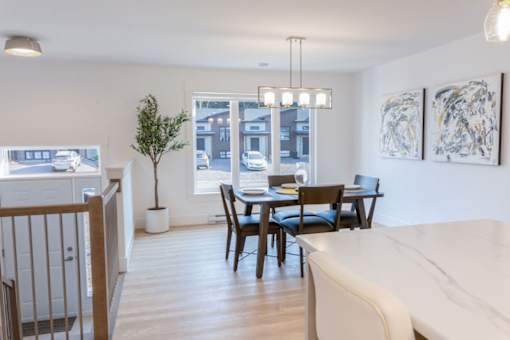 A dining room with a table set for four.