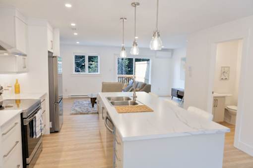 A modern kitchen with a large island and stainless steel appliances.