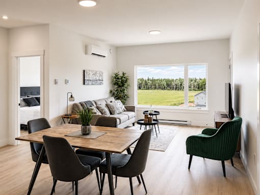 A modern dining room with a wooden table and chairs.