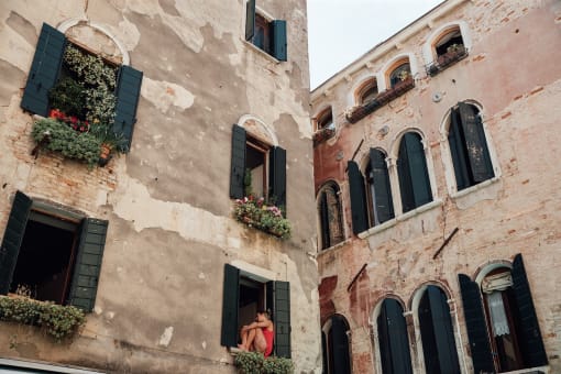 a woman looking out of a window of a building