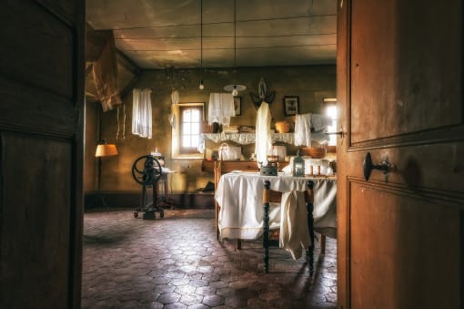 A kitchen with a table and a table cloth on it