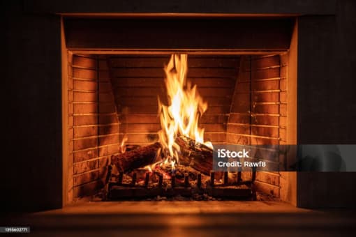 a roaring fire in a brick fireplace