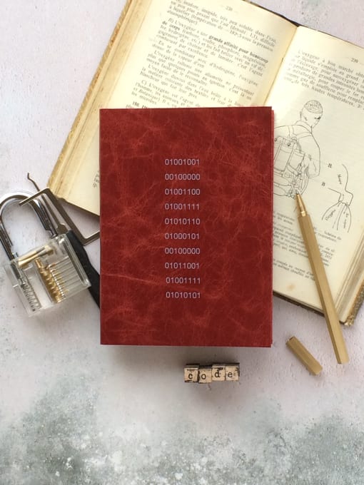 the book of numbers with a lock and a pencil on a table
