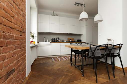a kitchen and dining area with a table and chairs