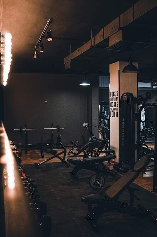 A gym with a variety of equipment including weights and machines.