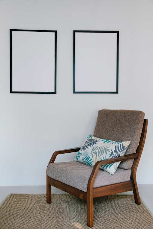 gray and wood chair in front of white wall