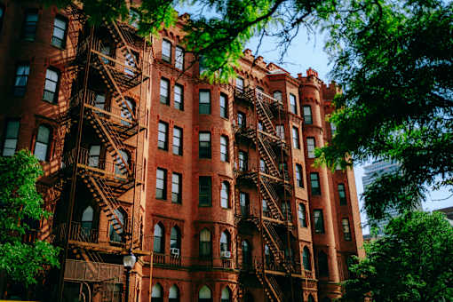 A red brick building with a fire escape on the side.