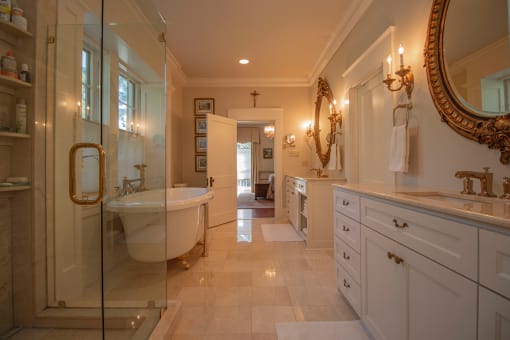 a bathroom with a tub and a shower and a sink