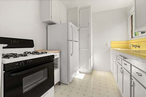 A kitchen with a black stove top oven, a white refrigerator, and white cabinets with yellow countertops.