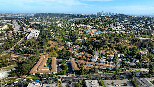 A bird's eye view of a city with a large building in the foreground.