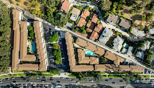 A bird's eye view of a residential area with houses and cars.