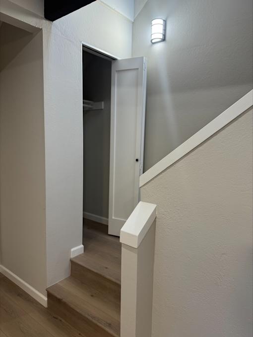 A white door is at the end of a staircase.