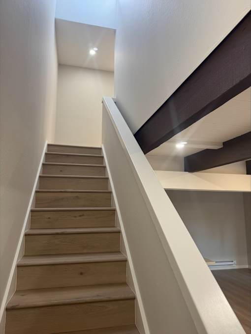 A staircase with wooden steps and white railings.