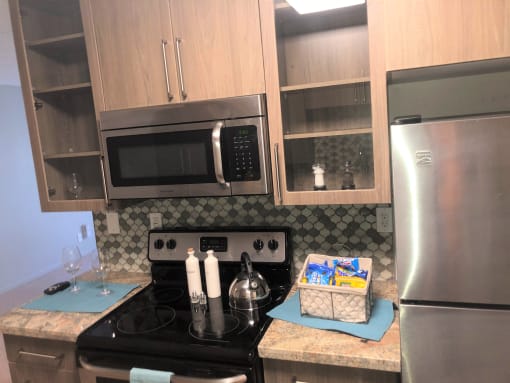 a kitchen with stainless steel appliances and wooden cabinets