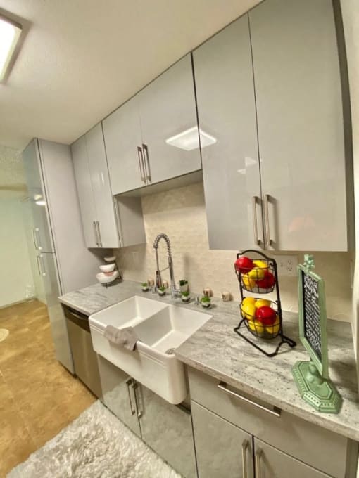 a kitchen with white cabinets and a sink