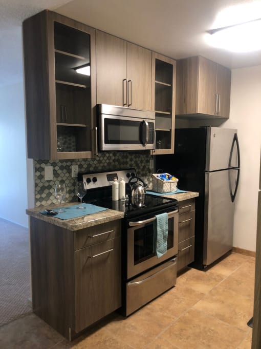 a kitchen with stainless steel appliances and wooden cabinets