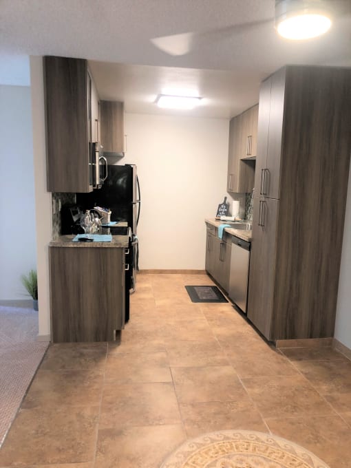 a kitchen with stainless steel appliances and wooden cabinets