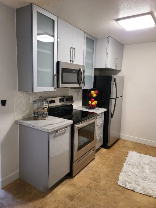 a kitchen with stainless steel appliances and white cabinets