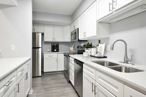 kitchen with all white cabinets, stainless steel appliances and breakfast bar
