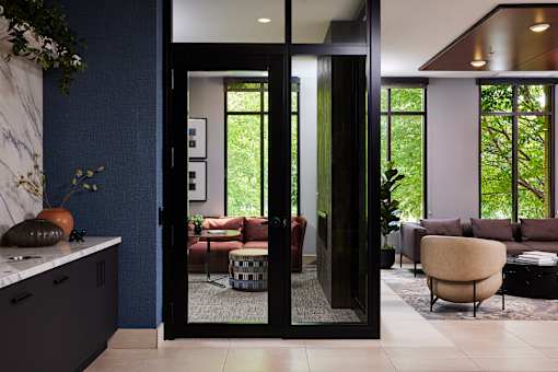 A modern living room with a glass door entrance.
