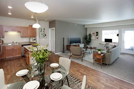 A modern kitchen with a dining table set for four.
