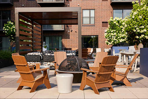 Four wooden chairs are arranged on a patio.