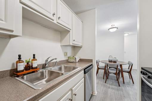 Kitchen with sink and dining room at The Bosk Apartment Homes, Woodbury, MN, 55125