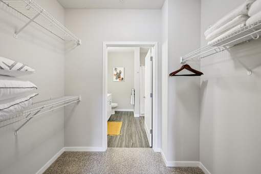 A hallway with white walls and a carpeted floor.