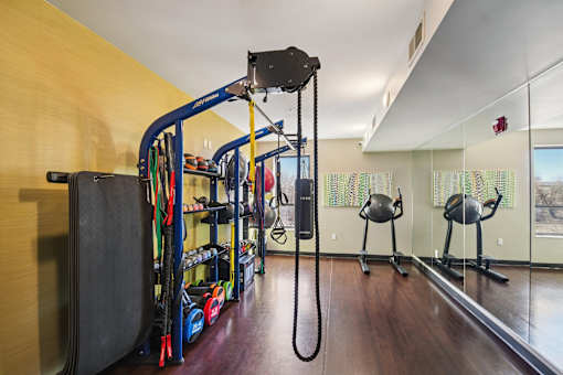 A gym with a variety of equipment including a cable machine.