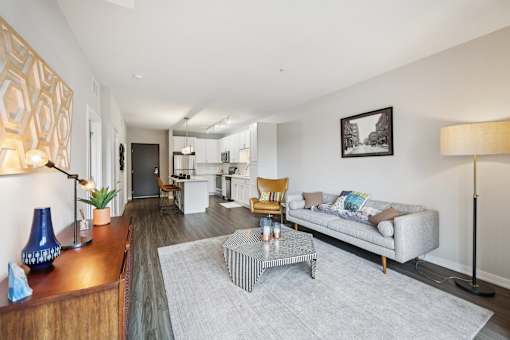 A living room with a grey sofa and a coffee table.