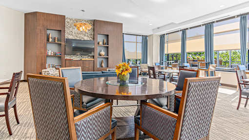 a dining room with tables and chairs and a large window