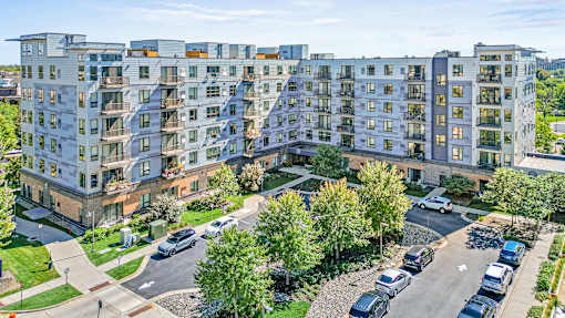 an aerial view of an apartment building on a city street