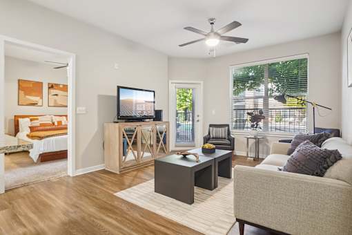 A living room with a television, couch, and a coffee table.