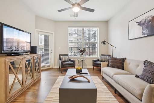 A living room with a television, couches, and a coffee table.