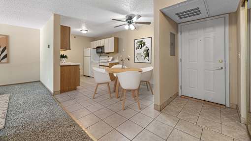 a dining room with a table and chairs and a kitchen