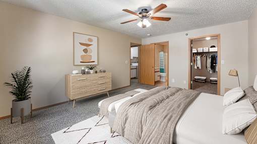 a bedroom with a large bed and a ceiling fan