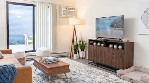 a living room with a couch and a coffee table at The Bosk Apartment Homes, Woodbury