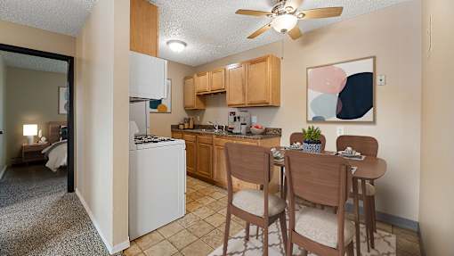 an open kitchen and dining area with a dining table and chairs