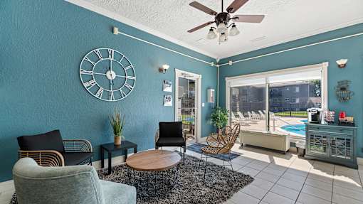 a living room with a large clock on the wall