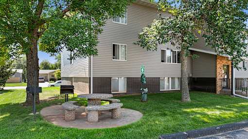 a stone picnic table in the yard of an apartment building